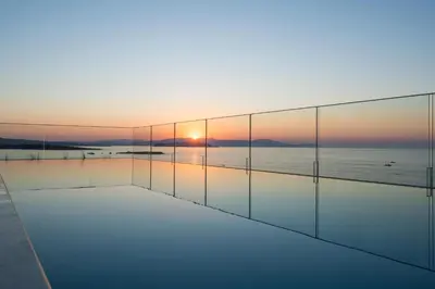 a room with a view of the ocean at sunset at SanSal Boutique Hotel in Chania Town