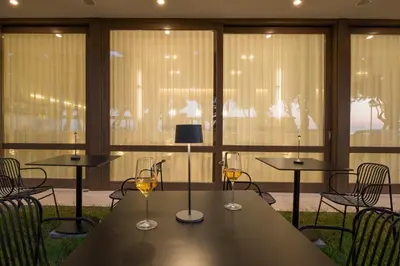 a table with two glasses of wine on it at SanSal Boutique Hotel in Chania Town