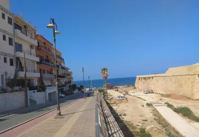 a view of a street with buildings and the ocean at Iris Apartment in Chania Town