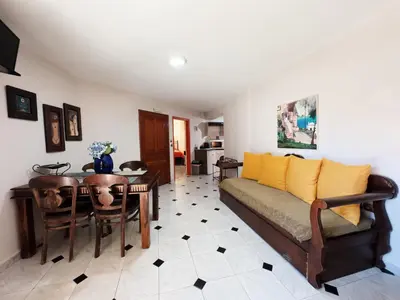 a living room with a couch and a table at Villa Eleni Seaside Apartments in Plataniás