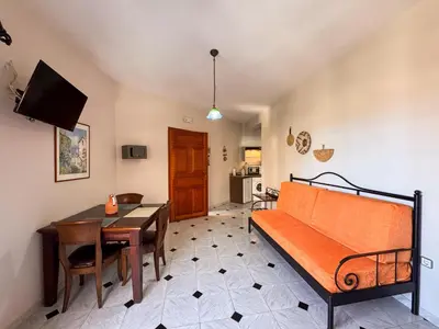 a living room with a couch and a table at Villa Eleni Seaside Apartments in Plataniás