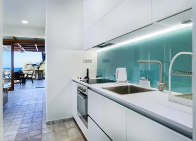 a kitchen with a sink and a view of the ocean at Xenios Dias Luxury Apartments With Sea View in Kato Daratso