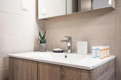 a bathroom with a white sink in a room at Casa Ntore Luxury Apartments in Chania Town