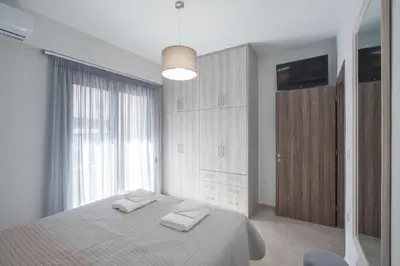 a bedroom with a bed with two towels on it at Casa Ntore Luxury Apartments in Chania Town