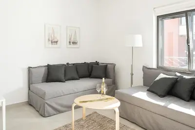 a living room with a couch and a table at Cozy Corner Luxury Apartments in Chania Town