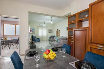 a kitchen and living room with a table with fruit on it at Ifigeneia's Lavish Escape with Private Hot Tub in Kalathas