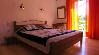 a bedroom with a large bed with purple sheets at Lion-Suites in Kalyves