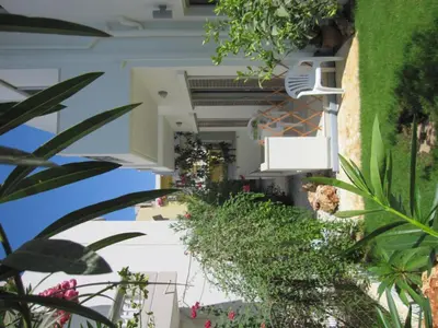 a hallway with plants on the side of a building at Lion-Suites in Kalyves
