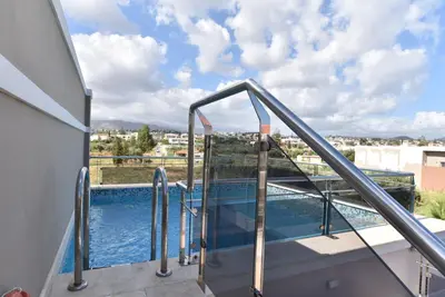 a swimming pool on the balcony of a house at Okeanis Golden Resort in Kato Daratso