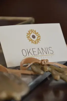 a white sign with the word oxfam on a laptop at Okeanis Golden Resort in Kato Daratso