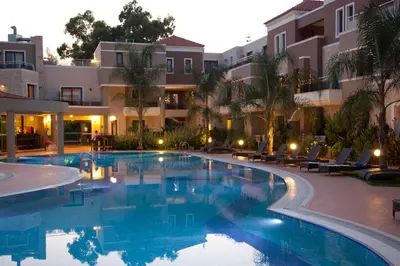 a swimming pool in front of a building at Okeanis Golden Resort in Kato Daratso