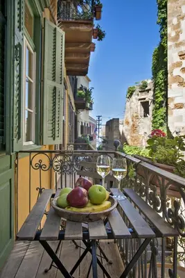 a plate of fruit on a table on a balcony at Antica Casa Studios in Chania Town