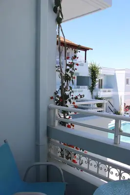 a balcony with a plant on the railing at Mastorakis Village in Agia Marina Nea Kydonias
