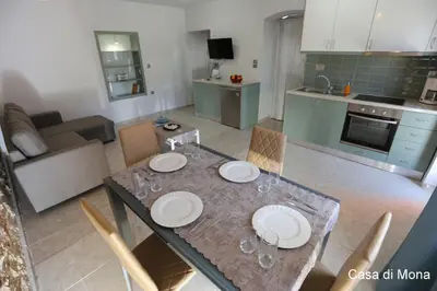 a kitchen with a dining table with plates on it at Casa di Mona in Chania Town