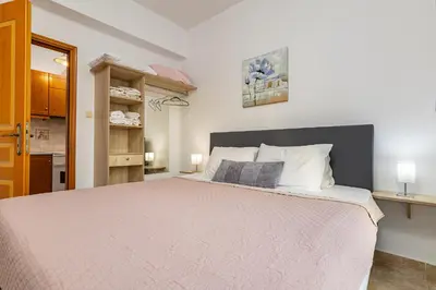 a bedroom with a large bed in a room at Panoramio Paleochora Apartments in Palaiochóra