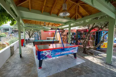 a ping pong table sitting under a pavilion at Stefan Village Hotel in Agia Marina Nea Kydonias