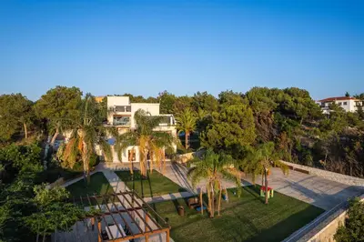 an aerial view of a resort with palm trees at Angels Villa - 8-Bedroom Estate Ideal for Groups & Families by etouri in Kambánion