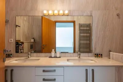 a bathroom with two sinks and a large mirror at Angels Villa - 8-Bedroom Estate Ideal for Groups & Families by etouri in Kambánion