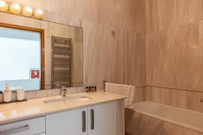 a bathroom with a sink and a tub and a mirror at Angels Villa - 8-Bedroom Estate Ideal for Groups & Families by etouri in Kambánion