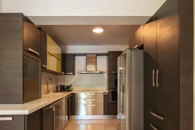 a kitchen with wooden cabinets and a kitchen island at Angels Villa - 8-Bedroom Estate Ideal for Groups & Families by etouri in Kambánion
