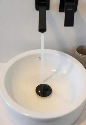 a stream of water pouring into a toilet bowl at Aegean Breeze Luxury Apartments next to the sea in Maleme