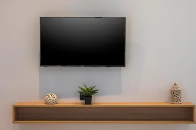 a flat screen tv hanging on a wall at Aegean Breeze Luxury Apartments next to the sea in Maleme