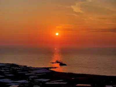 a sunset over the ocean with the sun in the sky at Riza Falasarna Apartments in Falasarna