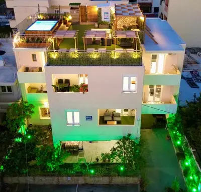an aerial view of a house at night with lights at Pearl Seaside Cozy Apartments in Chania Town