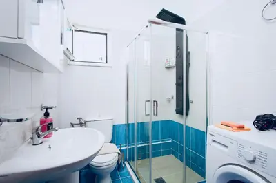 a bathroom with a toilet and a sink and a shower at Pearl Seaside Cozy Apartments in Chania Town