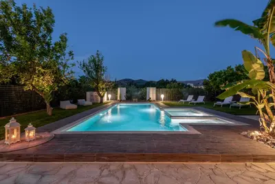 a swimming pool in a backyard at night at Elenas Village house - Dream apt w Pool & Terrace in Alikianós