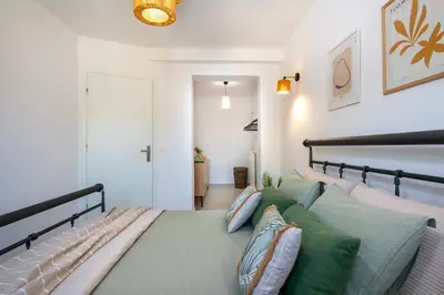 a bedroom with a large bed with pillows on it at Elenas Village house - Dream apt w Pool & Terrace in Alikianós