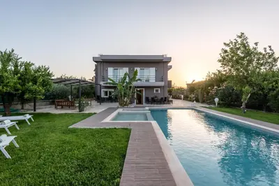 a house with a swimming pool in front of a house at Elenas Home - Dream & Love apts w Private pool in Alikianós