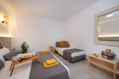 a living room with a bed and a couch at Elenas Home - Dream & Love apts w Private pool in Alikianós