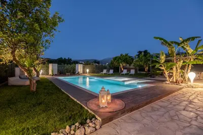 a swimming pool with a candle in the middle of a yard at Elenas Home - Dream & Love apts w Private pool in Alikianós