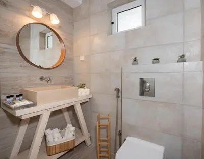 a bathroom with a sink and a mirror at Elenas Village House - Love apartment with Pool and Terrace in Alikianós