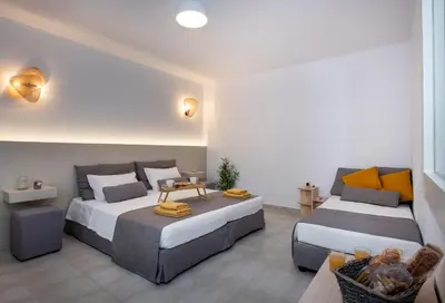 a bedroom with two beds and a couch at Elenas Village House - Love apartment with Pool and Terrace in Alikianós