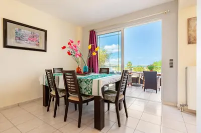 a dining room with a table and chairs at Wonderful Villa in Chania with Private Pool, Panoramic Sea Views & Spacious Interiors in Agios Onoufrios