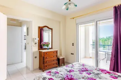 a bedroom with a bed and a dresser and a mirror at Wonderful Villa in Chania with Private Pool, Panoramic Sea Views & Spacious Interiors in Agios Onoufrios