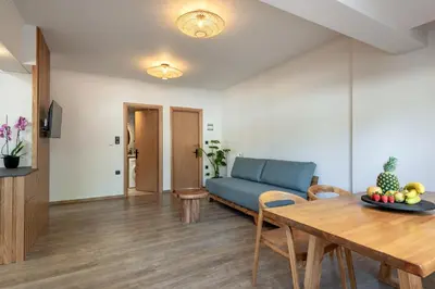 a living room with a blue couch and a table at Soleado Studio in Chania Town
