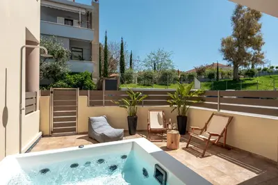 a balcony with a jacuzzi tub on a patio at Soleado Studio in Chania Town
