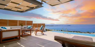 an outdoor patio with a view of the ocean at Amphitheatre Suites in Palaiochóra