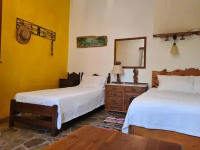 a bedroom with two beds and a mirror and a table at Spitia Anoi in Palaiochóra