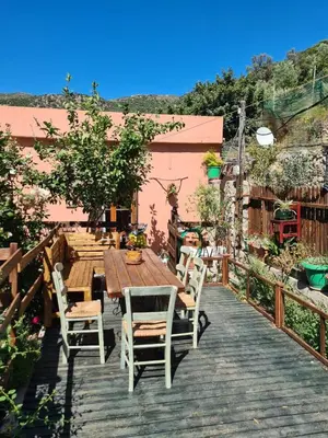 a wooden table and chairs on a wooden deck at Spitia Anoi in Palaiochóra