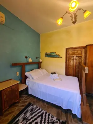 a bedroom with a white bed in a room at Spitia Anoi in Palaiochóra