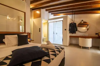 a bedroom with a large bed and a bathroom at Casa Bene in Chania Town