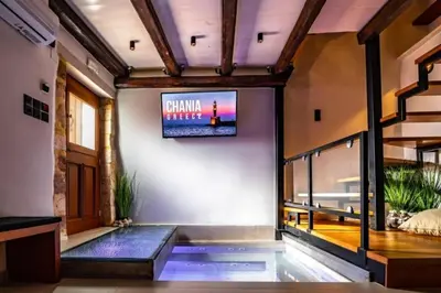 a living room with a tv on the wall at Casa Bene in Chania Town