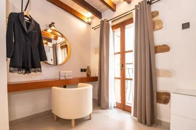 a dressing room with a mirror and a chair at Casa Bene in Chania Town