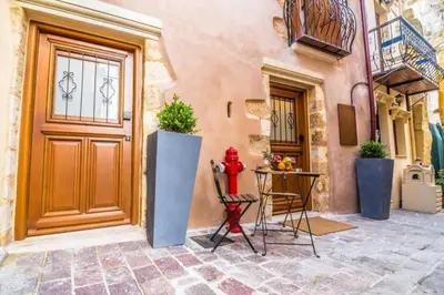 a red fire hydrant sitting in front of a building at Casa Bene in Chania Town
