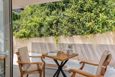 a table and two chairs on a patio at Lilium Luxury Suites in Agia Marina Nea Kydonias