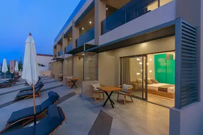 a apartment balcony with a bed and a table and chairs at Lilium Luxury Suites in Agia Marina Nea Kydonias
